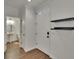 Bright foyer featuring wood-look flooring and a convenient powder room at 9506 Harpender Way, Tampa, FL 33626