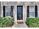Inviting front door with decorative trim and manicured landscaping at 9506 Harpender Way, Tampa, FL 33626
