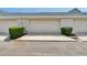 Attached garages lined with manicured hedges in a desirable community at 9506 Harpender Way, Tampa, FL 33626