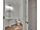Clean half-bath with pedestal sink, toilet, and decorative mirror at 9506 Harpender Way, Tampa, FL 33626