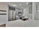 Modern kitchen features stainless steel appliances, stone countertops, gray cabinets, and a wine rack at 9506 Harpender Way, Tampa, FL 33626