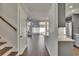 Hallway view with stairs and sightlines to the kitchen, breakfast bar and living area at 9506 Harpender Way, Tampa, FL 33626