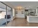 Combined living and dining areas open to the kitchen with stainless steel appliances and an outdoor view at 9506 Harpender Way, Tampa, FL 33626