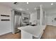 Kitchen with island, stainless steel appliances, gray cabinets, and white countertops at 9506 Harpender Way, Tampa, FL 33626