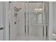 Updated walk-in shower with tiled walls, a glass sliding door, and modern fixtures at 9506 Harpender Way, Tampa, FL 33626