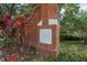 West Park Village brick and stone community sign from 1999 surrounded by trees at 9506 Harpender Way, Tampa, FL 33626