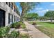 Sidewalk view of a well-maintained townhome exterior and manicured lawn at 9506 Harpender Way, Tampa, FL 33626