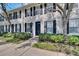 Close up view of an inviting townhome exterior showcasing manicured landscaping at 9506 Harpender Way, Tampa, FL 33626