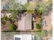 Aerial view of the home showing the roof, yard, and deck area amidst a neighborhood of lush landscaping at 9812 N Pawnee Ave, Tampa, FL 33617