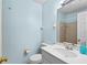 Bathroom featuring a vanity with sink, toilet, and shower with neutral wall color scheme at 9812 N Pawnee Ave, Tampa, FL 33617