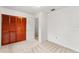 Bedroom featuring carpet floors, a closet with paneled doors, and neutral wall colors at 9812 N Pawnee Ave, Tampa, FL 33617