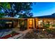 Charming home featuring stone accents, mature trees, and inviting front entrance under evening sky at 9812 N Pawnee Ave, Tampa, FL 33617