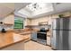 Well-lit kitchen features stainless steel appliances, ample cabinetry, and a skylight at 9812 N Pawnee Ave, Tampa, FL 33617
