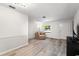 Inviting living room with stylish flooring, natural light, and a cozy seating area at 9812 N Pawnee Ave, Tampa, FL 33617