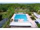 Aerial shot showcases a pool and community amenities surrounded by lush greenery and trees at 10309 Marchmont Ct, Tampa, FL 33626