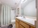 Well-lit bathroom featuring a shower-tub combo and ample counter space at 10309 Marchmont Ct, Tampa, FL 33626