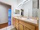 Bright bathroom features a double sink vanity with two mirrors and tile flooring at 10309 Marchmont Ct, Tampa, FL 33626