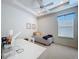 Bedroom with a large window, day bed, and tray ceiling with recessed lighting at 10309 Marchmont Ct, Tampa, FL 33626