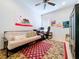 Bedroom featuring a futon, desk area, and custom artwork at 10309 Marchmont Ct, Tampa, FL 33626