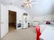 Bright bedroom features neutral carpeting, ceiling fan, and white furniture for a cozy feel at 10309 Marchmont Ct, Tampa, FL 33626