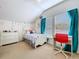 Bright bedroom with a desk, red chair, large window, and white furniture at 10309 Marchmont Ct, Tampa, FL 33626