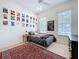 Bedroom with a large area rug, posters on the wall, and two windows at 10309 Marchmont Ct, Tampa, FL 33626