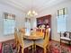 Inviting dining room features coffered ceiling, a wooden table set for six, and window lighting at 10309 Marchmont Ct, Tampa, FL 33626