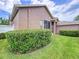 Exterior view of the home shows the backyard, landscaping and screened porch at 10309 Marchmont Ct, Tampa, FL 33626