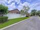 Street view of the home showing a well-manicured lawn and a white fence enhancing its aesthetic appeal at 10309 Marchmont Ct, Tampa, FL 33626