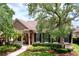 Charming two-story home featuring a cozy front porch, manicured landscaping and decorative shutters at 10309 Marchmont Ct, Tampa, FL 33626