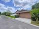 Home's two-car garage features a neutral paint scheme, enhancing its curb appeal on the well-kept street at 10309 Marchmont Ct, Tampa, FL 33626