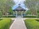 Picturesque gazebo surrounded by landscaped gardens and brick pathways creating a serene outdoor space at 10309 Marchmont Ct, Tampa, FL 33626