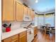 Functional kitchen includes light wood cabinetry, white appliances, and a cozy breakfast nook at 10309 Marchmont Ct, Tampa, FL 33626
