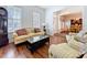 Cozy living room featuring hardwood floors, sofas, and large windows at 10309 Marchmont Ct, Tampa, FL 33626