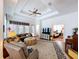 Spacious living room with tray ceilings, ceiling fan, and a decorative rug at 10309 Marchmont Ct, Tampa, FL 33626