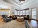 Spacious living room with natural light, ceiling fan, and plush seating at 10309 Marchmont Ct, Tampa, FL 33626