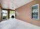 Enclosed patio with a ceiling fan, exterior access, and space for a grill at 10309 Marchmont Ct, Tampa, FL 33626