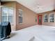 Enclosed patio with a ceiling fan, exterior access, and space for a grill at 10309 Marchmont Ct, Tampa, FL 33626