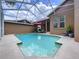 Sparkling private pool surrounded by a screened enclosure and neutral colored patio at 10309 Marchmont Ct, Tampa, FL 33626