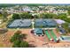 Aerial view of tennis and bocce ball courts amidst green spaces in a vibrant community setting at 10309 Marchmont Ct, Tampa, FL 33626