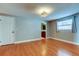Bedroom with wood floor, window, closet and entry to bath at 1041 Persimmon Dr, Palm Harbor, FL 34683