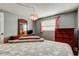 Peaceful bedroom with warm wood accents, a modern light fixture, and natural light at 1041 Persimmon Dr, Palm Harbor, FL 34683
