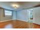 Bedroom with wood floor, window, closet and entry to bath at 1041 Persimmon Dr, Palm Harbor, FL 34683