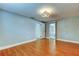 Bedroom with wood floor, closet and entry to bath and access to outside at 1041 Persimmon Dr, Palm Harbor, FL 34683