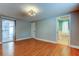 Bedroom with wood floor, slider, closet and entry to bath at 1041 Persimmon Dr, Palm Harbor, FL 34683