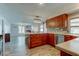 A gourmet kitchen features wood cabinets, stainless appliances, and an open design at 1041 Persimmon Dr, Palm Harbor, FL 34683