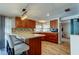 Kitchen with bar seating, warm lighting, and stainless steel appliances at 1041 Persimmon Dr, Palm Harbor, FL 34683
