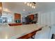 Bright kitchen with bar stools, stainless steel appliances, and ample counter space at 1041 Persimmon Dr, Palm Harbor, FL 34683