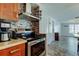A kitchen with stainless steel appliances, tiled backsplash, and modern fixtures at 1041 Persimmon Dr, Palm Harbor, FL 34683