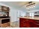 Kitchen with a stainless steel oven, a range hood, and modern cabinets at 1041 Persimmon Dr, Palm Harbor, FL 34683